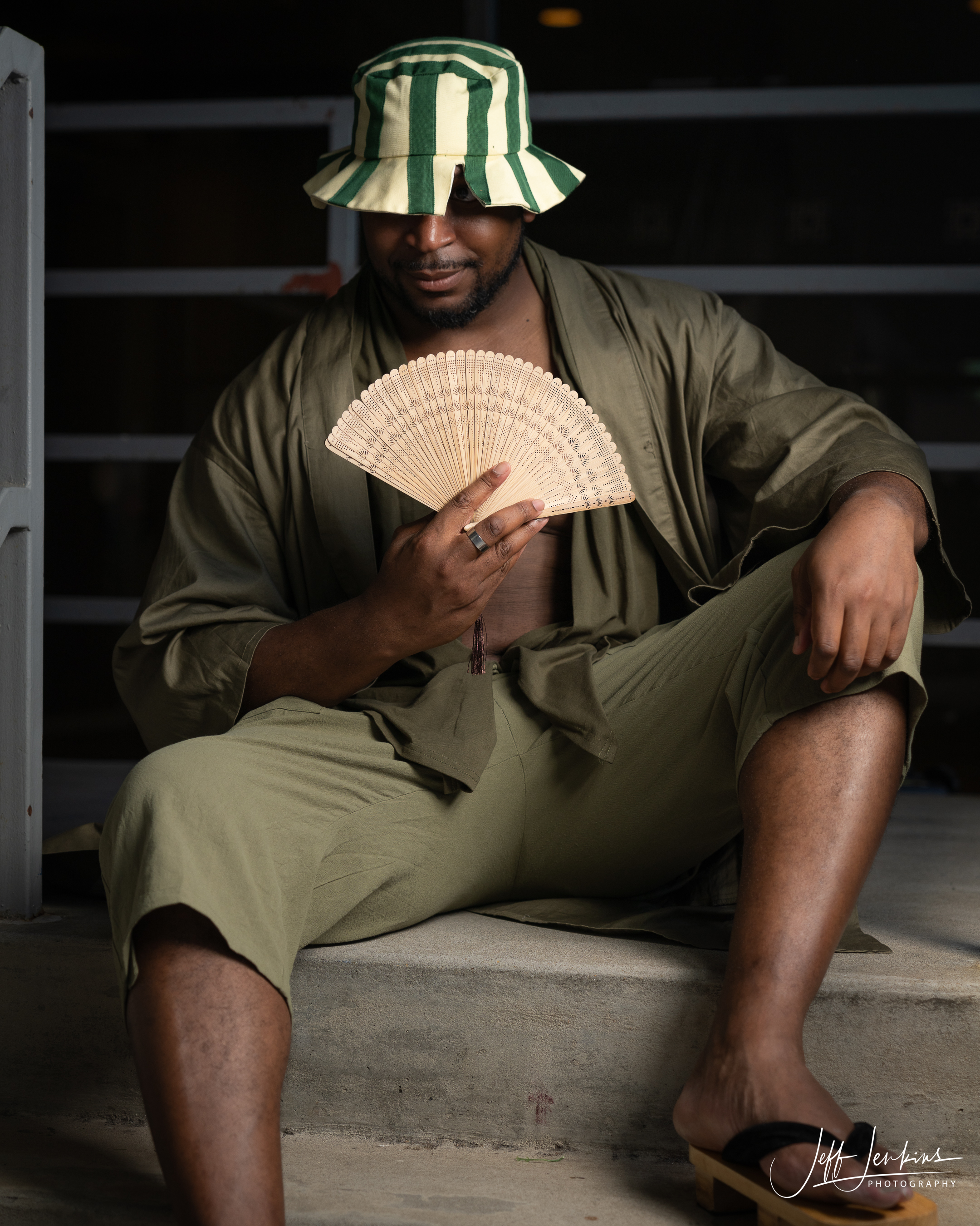 Urahara Kisuke from Bleach with striped hat and fan