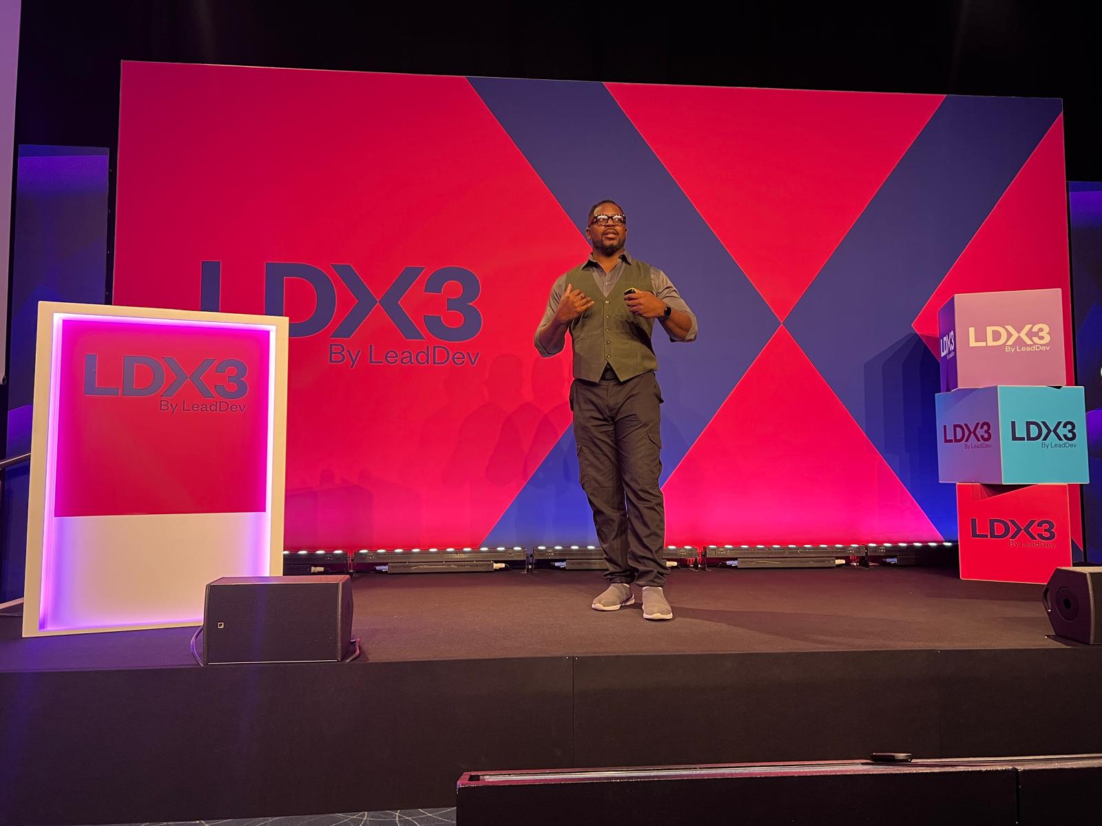 Ugo speaking on stage at a cosplay convention panel